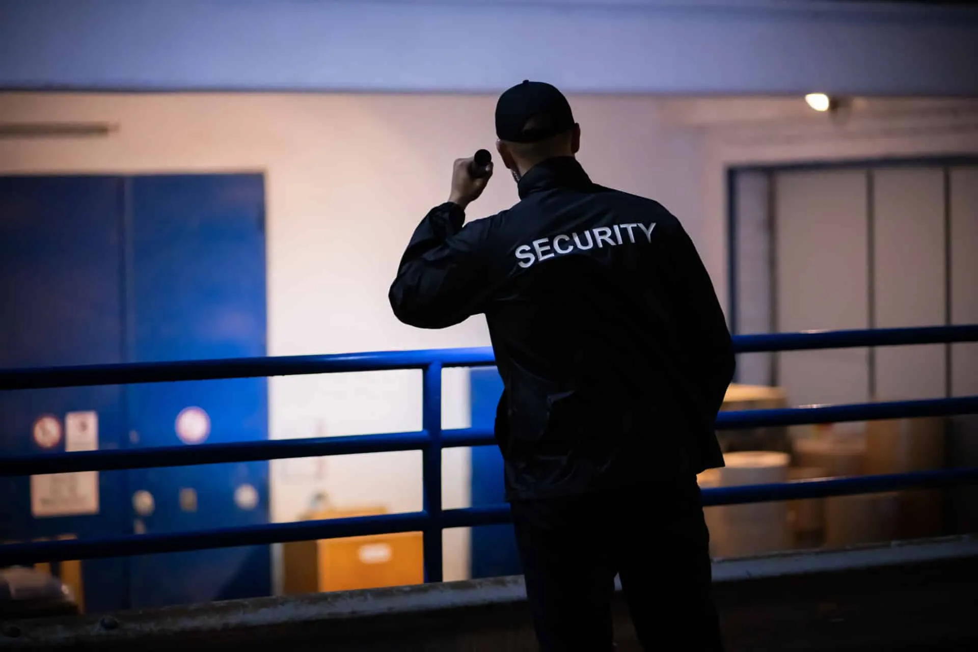 Security guard monitoring commercial property entrance